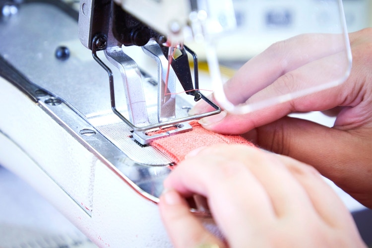 A David Nieper seamstress altering a garment